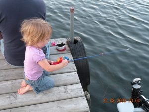 Girl fishing from resort dock